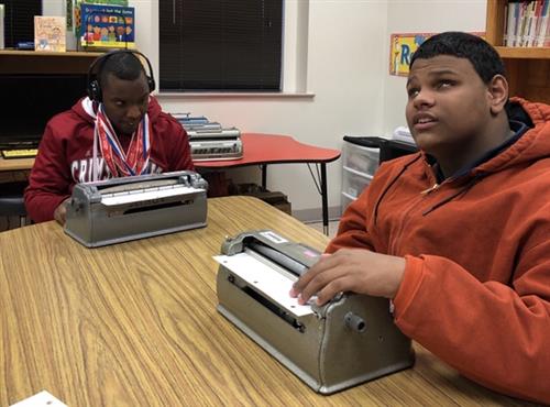 two boys on their braille writers 